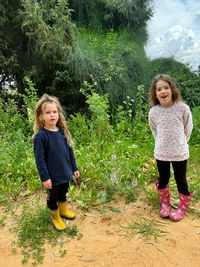 Portrait of smiling young woman standing on field