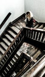 High angle view of woman standing on staircase