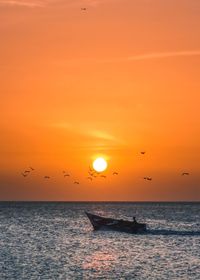 Scenic view of sea against orange sky