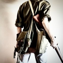 Low section of man standing against white background