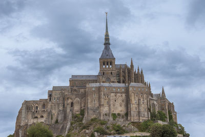 Low angle view of cathedral against cloudy sky