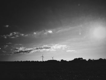 Scenic view of silhouette field against sky during sunset