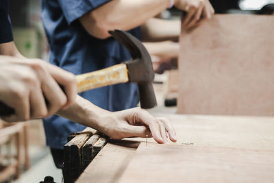 Midsection of man working on table