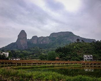 Scenic view of field and mountains against sky