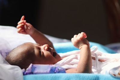 Close-up of baby sleeping on bed