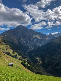 Scenic view of landscape and mountains against sky
