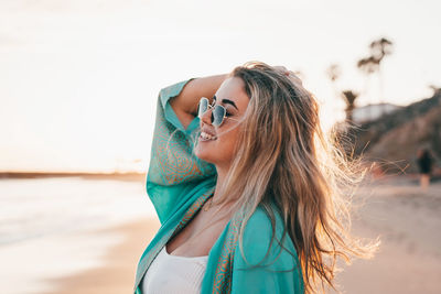 Young woman with eyes closed standing outdoors