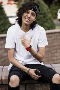 Portrait of young woman sitting outdoors