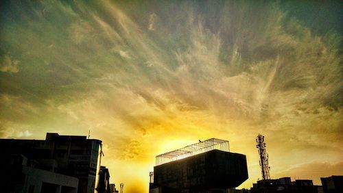 Low angle view of building against cloudy sky