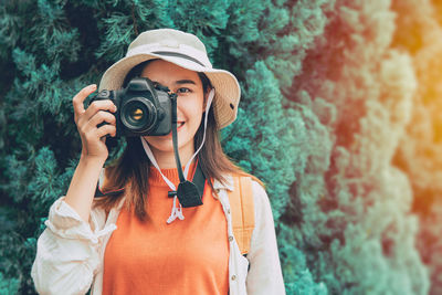 Midsection of woman holding camera