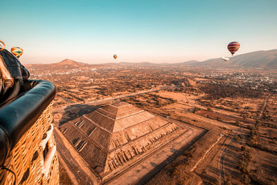 Aerial view of hot air balloon flying over landscape