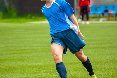 Midsection of man playing soccer