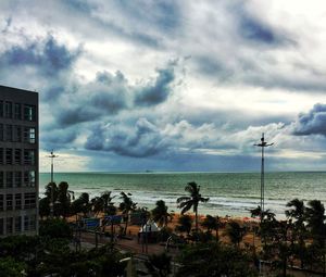 Scenic view of beach and buildings against sky