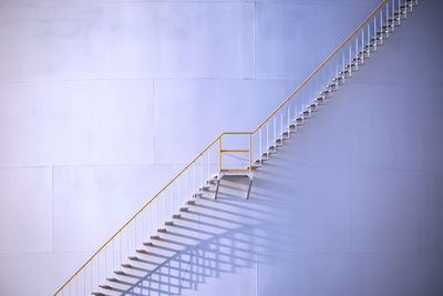 Low angle view of staircase against white wall