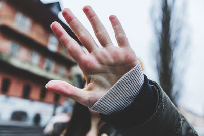 Close-up of woman hand on snow