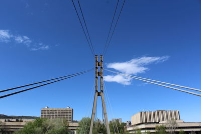 Low angle view of cables against blue sky