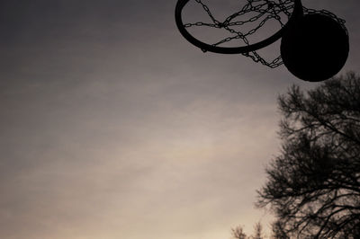 Low angle view of bare trees against sky