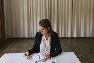 Young woman sitting on table