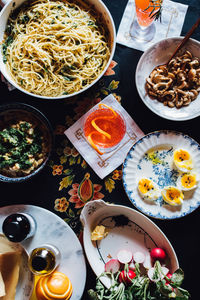 Top down view of table with colorful meal with soft boiled eggs and mushrooms and red stools