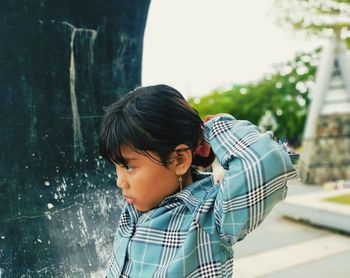 Side view of boy looking at camera