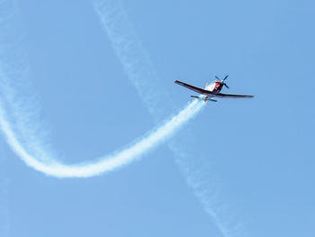 Low angle view of airplane flying in sky