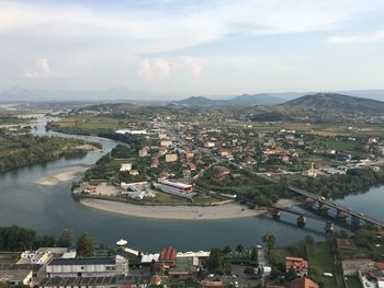 High angle view of river amidst cityscape against sky