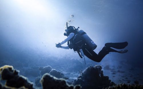 Low angle view of man swimming in sea