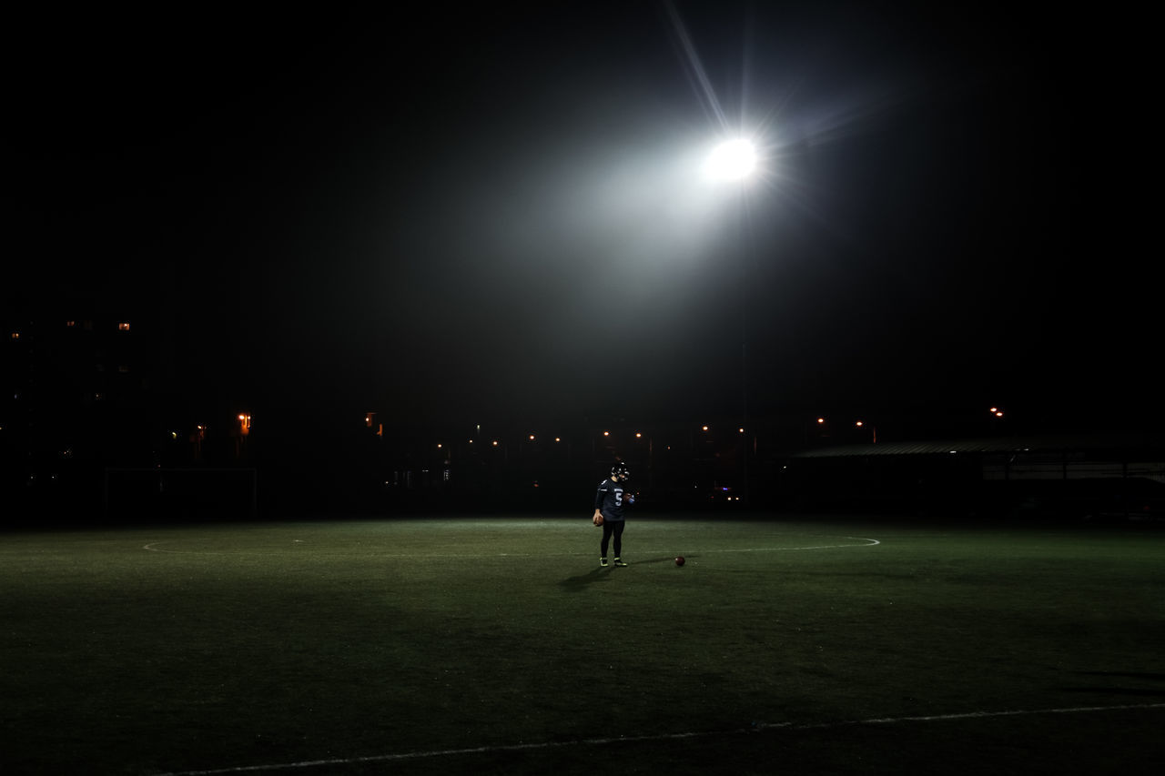 MAN PLAYING WITH BALL IN BACKGROUND