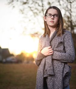 Portrait of young woman against sunset