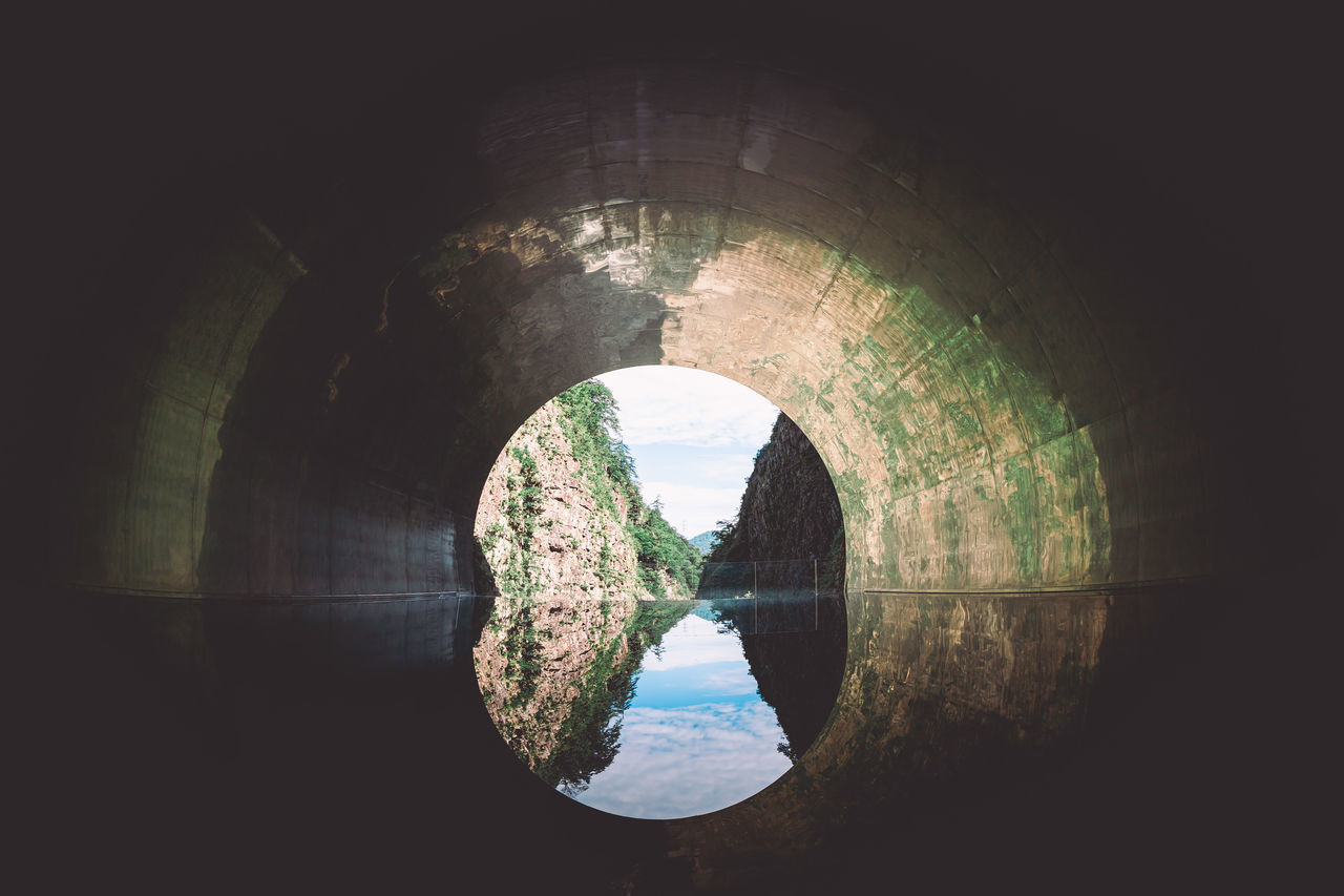 cave, architecture, tunnel, built structure, darkness, water, no people, arch, nature, light, reflection, indoors, light at the end of the tunnel, day, wall - building feature, dark, geometric shape