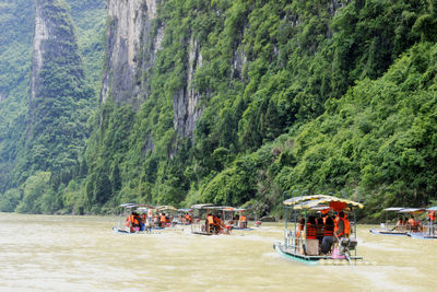 People in boats on river