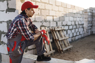 Side view of young man using mobile phone