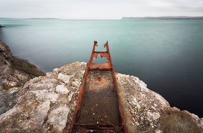 Abandoned pier by sea