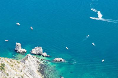 High angle view of sailboats in sea