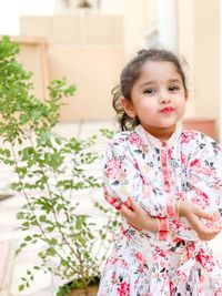 Portrait of cute girl standing outdoors