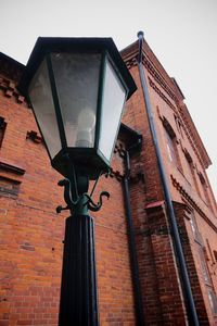 Low angle view of street light against building
