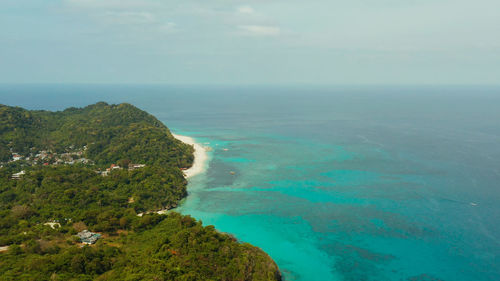 The famous tropical island of boracay with white beach, hotels among the forest, aerial view. 