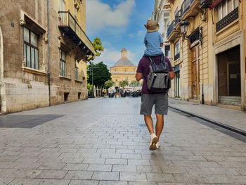 Rear view of woman walking on street