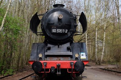 Close-up of locomotive amidst trees