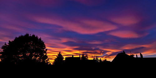 Scenic view of silhouette trees against sky at sunset