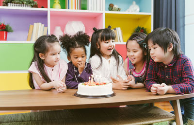 Children with cake at preschool classroom