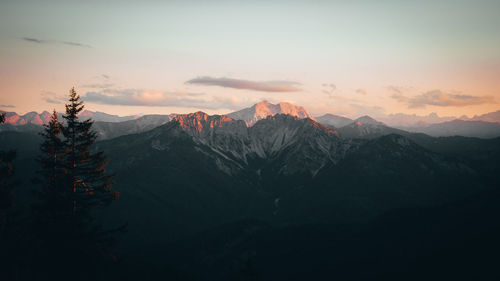 Scenic view of mountains against sky at sunset