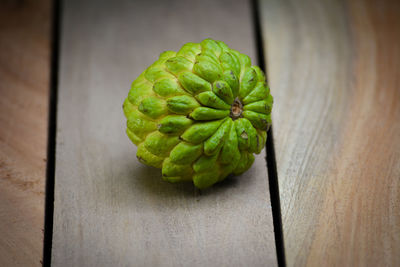 Close-up of green leaf on table