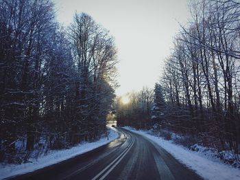 Road passing through snow covered landscape