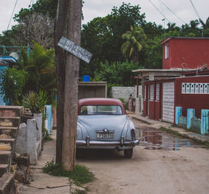 Car on street against buildings in city