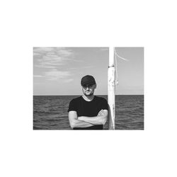 Portrait of young man against sea against sky