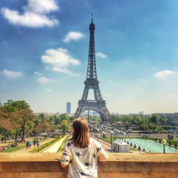 Rear view of young woman against eiffel tower