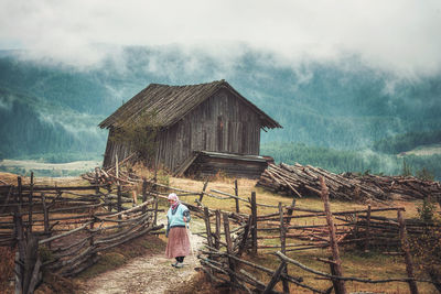 Rear view of person on wooden house