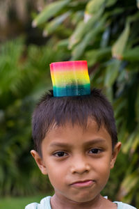 Close-up portrait of boy with colorful toy at park