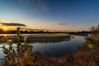 Scenic view of lake against sky during sunset